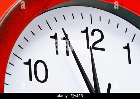Wall clock showing five to twelve Stock Photo