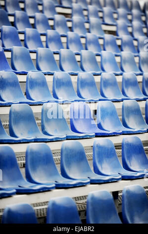 Empty blue seats on sport arena tribune after the rain Stock Photo