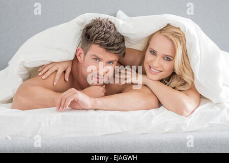 Middle Age Sweet Lovers on White Bed Stock Photo