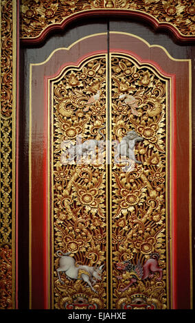 Ornate decorative door of a Hindu temple in Ubud in Bali in Indonesia in Southeast Asia. Religion Religious Art Culture Balinese Wanderlust Travel Stock Photo