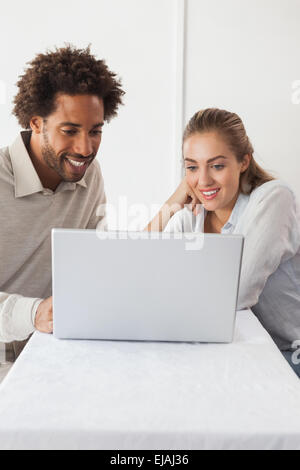 Happy couple on a date using laptop Stock Photo