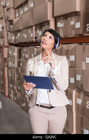 Pretty warehouse manager using tablet pc Stock Photo