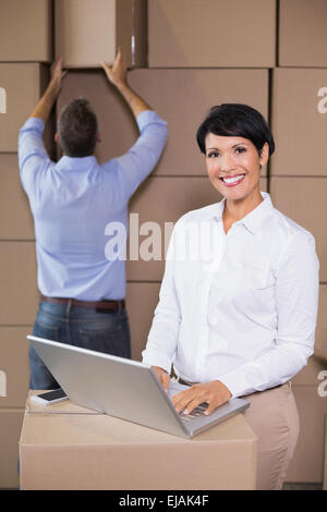 Pretty warehouse manager using laptop Stock Photo