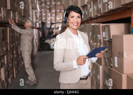 Pretty warehouse manager using tablet pc Stock Photo