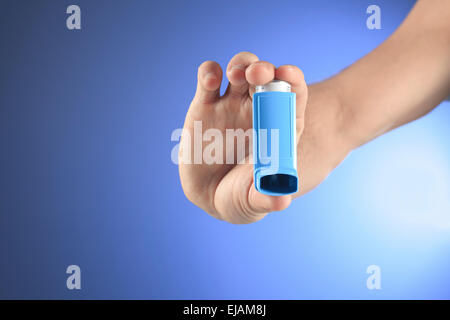 hand using an asthma inhalator Stock Photo
