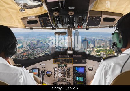 Pilots in the plane cockpit and city Stock Photo