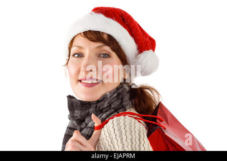 Smiling woman wearing santa hat Stock Photo