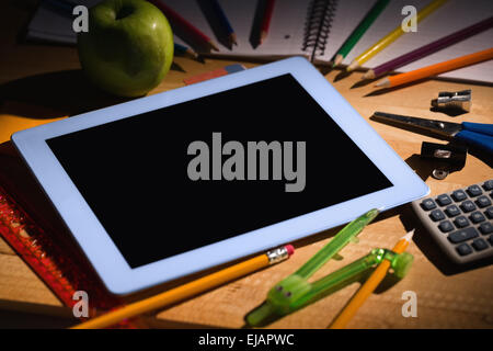 Students table with school supplies Stock Photo