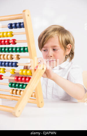 Student doing maths on abacus Stock Photo