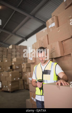 Worker scanning package in warehouse Stock Photo