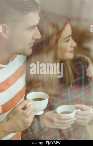 Cute couple looking out the window Stock Photo