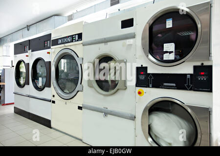 Automatic washing machines in laundrette Stock Photo