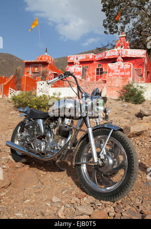 Indian manufactured Royal Enfield motorcycle outside Hindu temple near Pushkar, Rajasthan Stock Photo