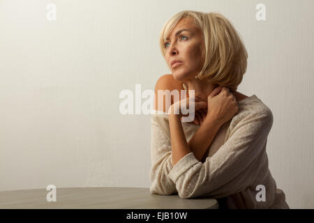 beautiful woman sitting at the table Stock Photo