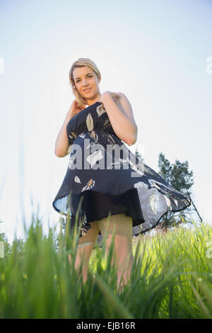 Pretty blonde in sundress smiling at camera Stock Photo