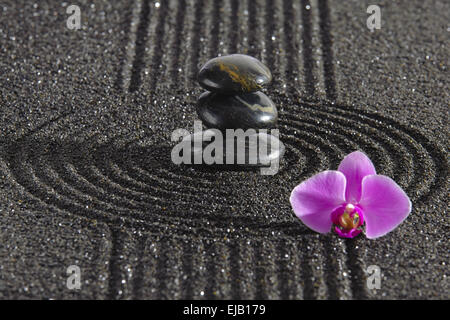 Japanese Zen garden with stacked stones mirroring in water Stock