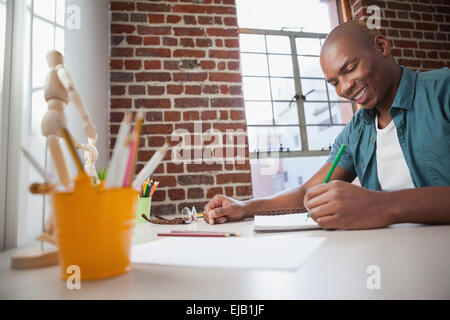 Designer sketching on paper with pencil Stock Photo