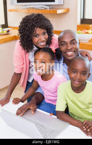 Happy family using the laptop together Stock Photo