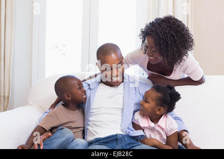 Happy family posing on the couch together Stock Photo