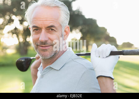 Smiling handsome golfer looking at camera Stock Photo