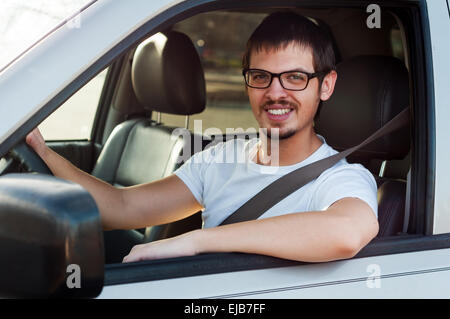 Male caucasian good driver is smiling in his car Stock Photo