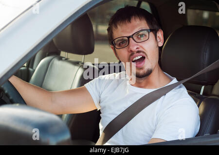 Male stupid face european driver is opening his mouth Stock Photo