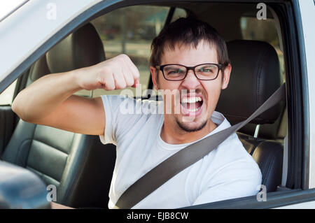 Male white angry driver is showing his fist and mad face Stock Photo