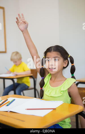 Cute pupils colouring at desks in classroom Stock Photo