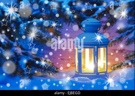 candle light lantern in snow at christmas Stock Photo