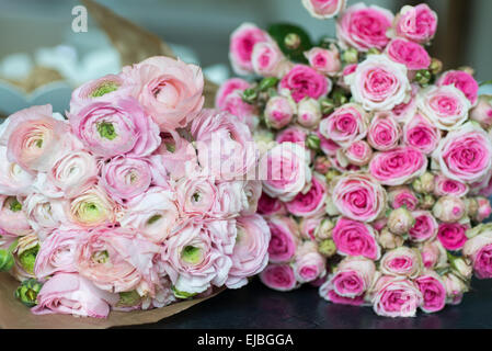Bouquet of pink ranunculus and Mimi Eden spray roses in Paris apartment Stock Photo