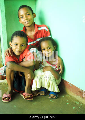 BIG CORN ISLAND, NICARAGUA-NOVEMBER  8:  Family portrait of three unidentified young brothers and sister happy and smiling on Bi Stock Photo
