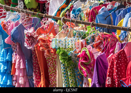 Traditional Flamenco dresses or Traje de Gitana. Rows of secondhand used dresses in the Thursday Flea market in Seville. Stock Photo