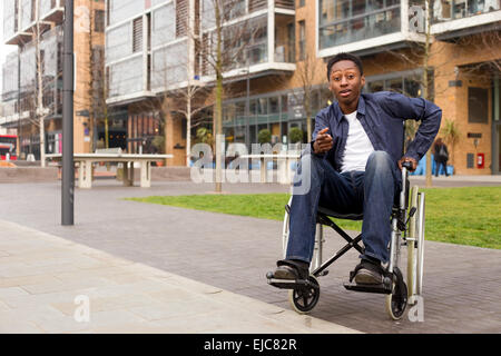 a young wheelchair user looking surprised. Stock Photo