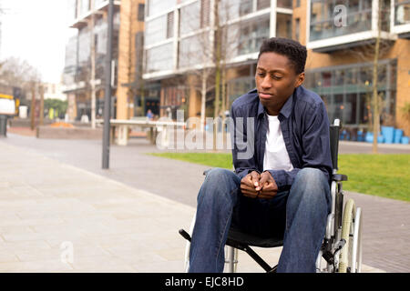 a young wheelchair user looking worried. Stock Photo