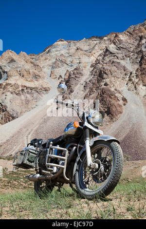 Indian manufactured Royal Enfield motorcycle with crash bars and racks at Sarchu high in the Himalayan region of Ladakh Stock Photo