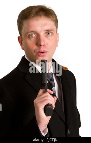 The man in a suit aims from a pistol Stock Photo