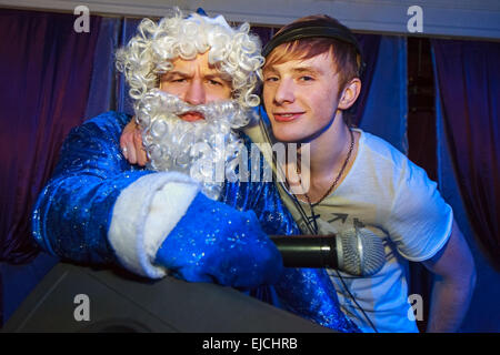 Santa and DJ together at a party Stock Photo