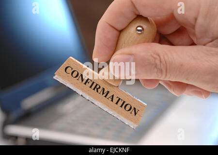 confirmation marked on rubber stamp Stock Photo