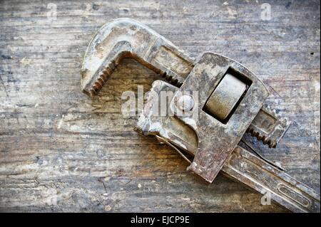 Old Rustic Wrench on Wood Stock Photo