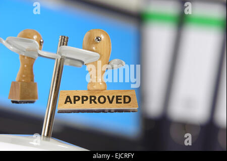 rubber stamp in office marked with approved Stock Photo