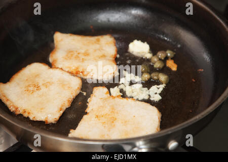 fry the meat in a frying pan Stock Photo