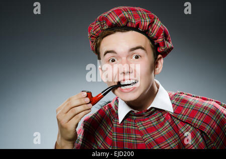 Funny scotsman smoking pipe tobacco Stock Photo