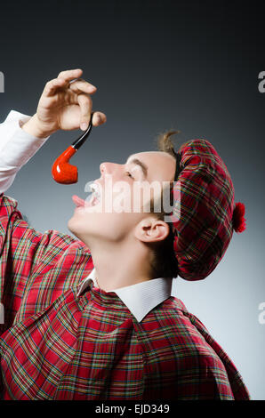 Funny scotsman smoking pipe tobacco Stock Photo