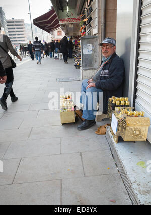 Izmir, Turkey - February 7, 2015: Senior shoeshine man sitting on his workplace and waiting for clients Stock Photo