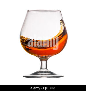 Splash of cognac in glass Stock Photo