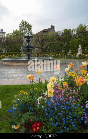 Fountain and blooming flowers at Place Albert Sorel in Honfleur, France Stock Photo