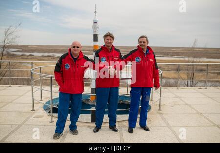 International Space Station Expedition 43 Commander NASA Astronaut Scott Kelly, left, and Russian Cosmonauts Gennady Padalka, center, and Mikhail Kornienko pose for a group photo near a model of the Soyuz rocket during media day March 21, 2015 in Baikonur, Kazakhstan. Kelly and cosmonauts Mikhail Kornienko and Gennady Padalka launch in their Soyuz TMA-16M spacecraft on March 28 for a year long mission onboard the ISS. Stock Photo