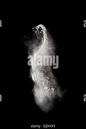 Abstract design of white powder cloud against dark Stock Photo