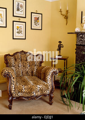 Faux leopard-skin upholstered armchair in nineties living room Stock Photo