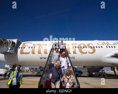 Passengers disembarking an Emirates airplane